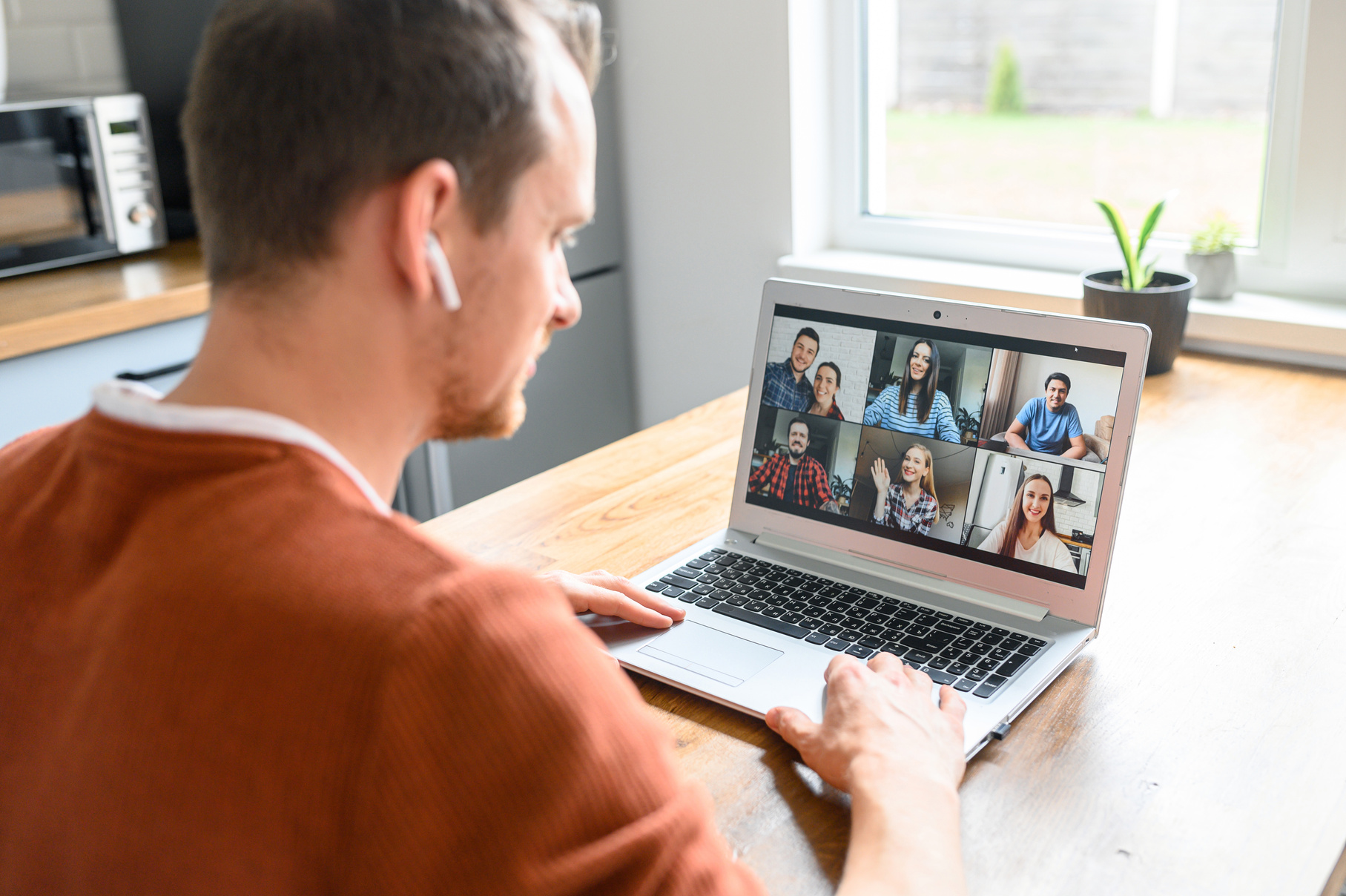 A guy is using laptop for video call, zoom